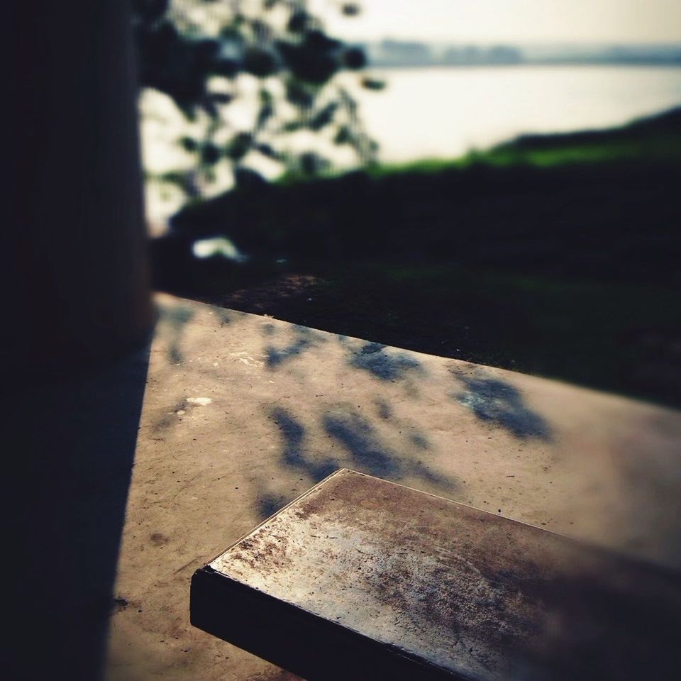 indoors, selective focus, close-up, architecture, built structure, focus on foreground, shadow, no people, wall - building feature, day, building exterior, sunlight, part of, cropped, high angle view, home interior, textured, wood - material, old