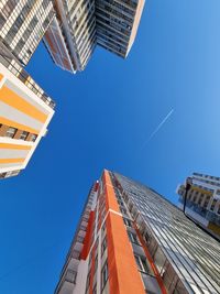 Low angle view of modern buildings against clear blue sky