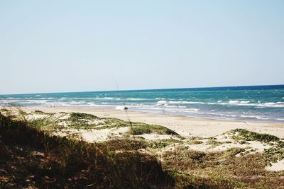 Scenic view of beach against clear sky