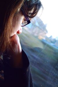 Close-up of girl looking through car window