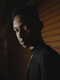 Side view of young man looking through window