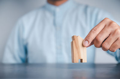 Close-up of man holding wood at home