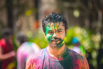 Portrait of man with face paint standing outdoors