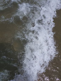 High angle view of waves in sea against sky