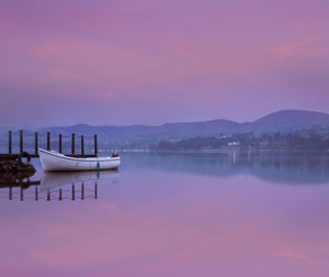 Scenic view of lake against sky at sunset