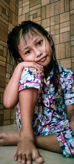 Portrait of smiling girl sitting outdoors