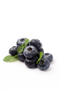 Close-up of blueberries against white background