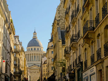 Low angle view of buildings against sky in city