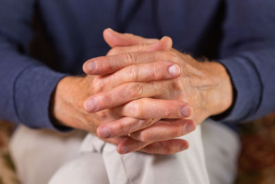 Midsection of couple holding hands