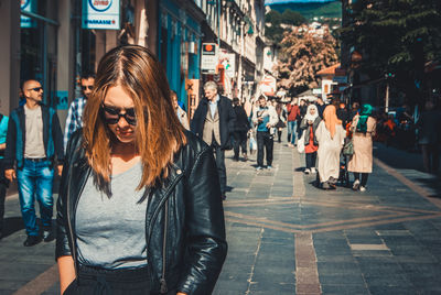 Portrait of smiling young woman in city