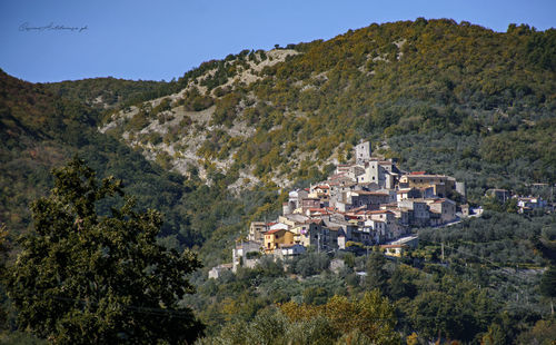 High angle view of houses and mountains against clear sky