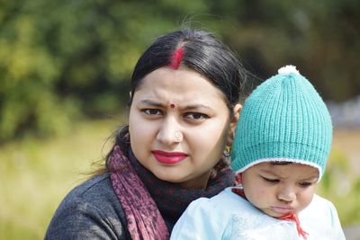 Portrait of a smiling woman with her daughter