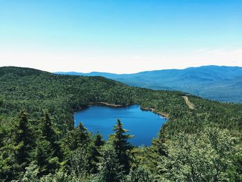 Scenic view of mountains against blue sky
