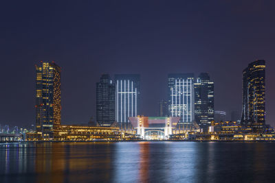 Illuminated buildings in city at night