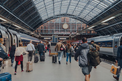 People walking on railroad station platform