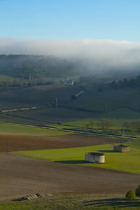 Scenic view of agricultural field against sky