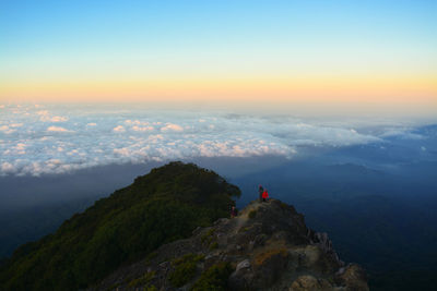 Climber and sunrise on mount raung