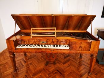 High angle view of piano on hardwood floor