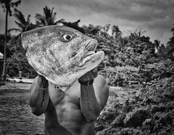 Midsection of person holding fish