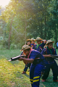 Boys in school uniform playing on field