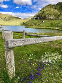Scenic view of grassy field against cloudy sky
