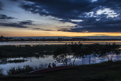 Scenic view of lake against sky during sunset