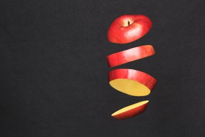 Directly above shot of apple on table against black background