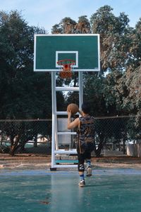 Men playing basketball hoop