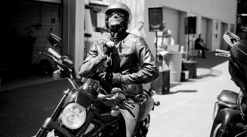 People riding motorcycle on road in city