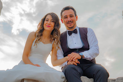 Young couple sitting outdoors