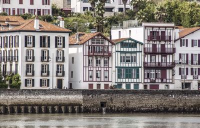 Residential buildings by river in town