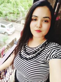 Portrait of beautiful young woman standing outdoors