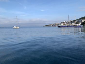 Sailboats sailing in sea against sky in cesme