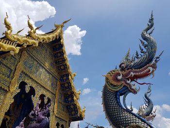 Low angle view of statue against building in thailand temple has naka statue