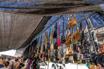 Low angle view of people at market against buildings in city