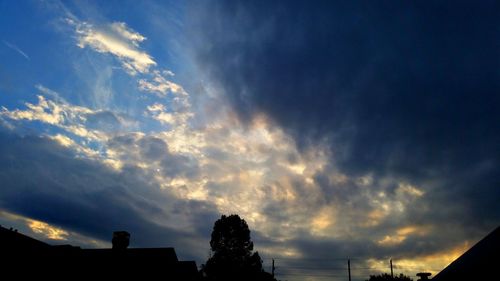 Low angle view of silhouette trees against sky at sunset