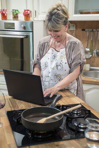 Woman using laptop at home