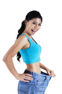 Portrait of smiling young woman against white background