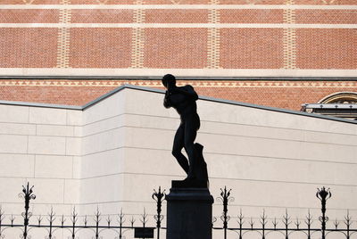 Low angle view of statue against building