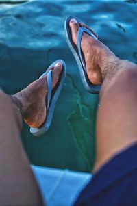 Low section of man over swimming pool