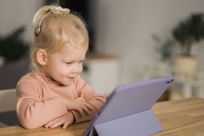 Portrait of cute boy using laptop at home