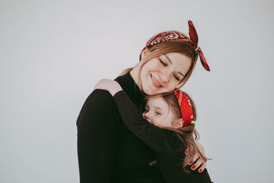 Portrait of young woman wearing santa hat against white background