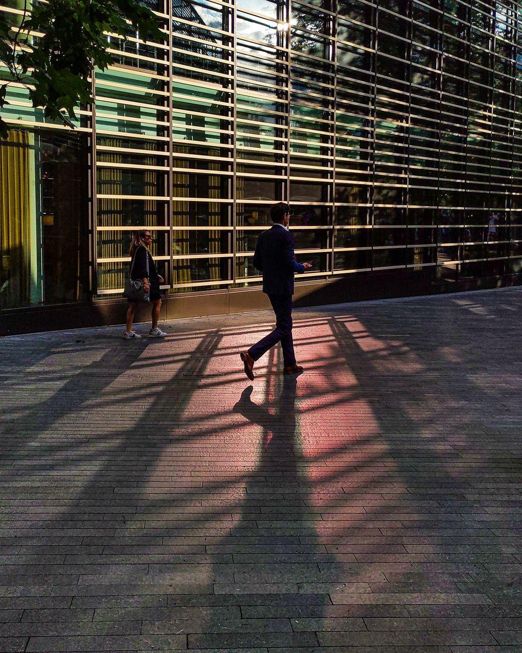 shadow, real people, men, sunlight, walking, full length, architecture, lifestyles, nature, people, day, built structure, women, city, rear view, two people, footpath, leisure activity, outdoors, adult