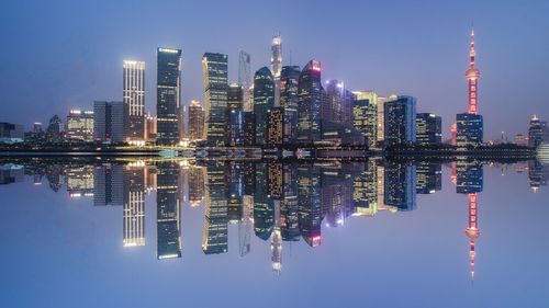 Reflection of illuminated buildings in city