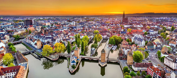 High angle view of city buildings against sky during sunset