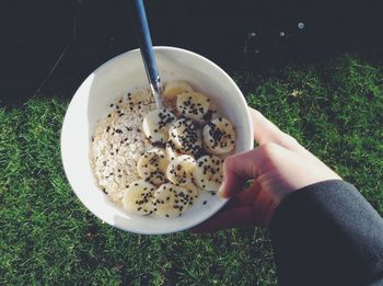 Cropped image of person holding bowl