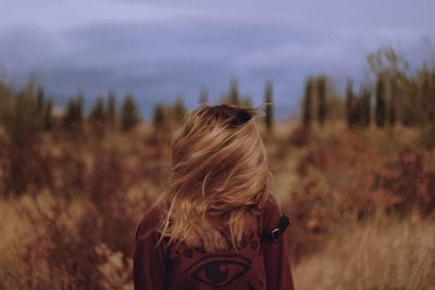 Teenage girl tossing hair on land