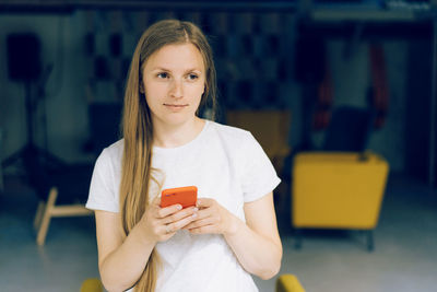 Portrait of woman holding mobile phone
