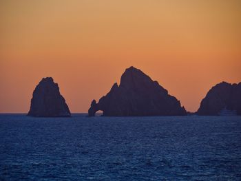 Scenic view of sea against orange sky