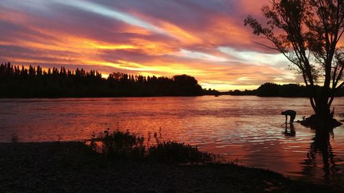 Scenic view of lake against orange sky